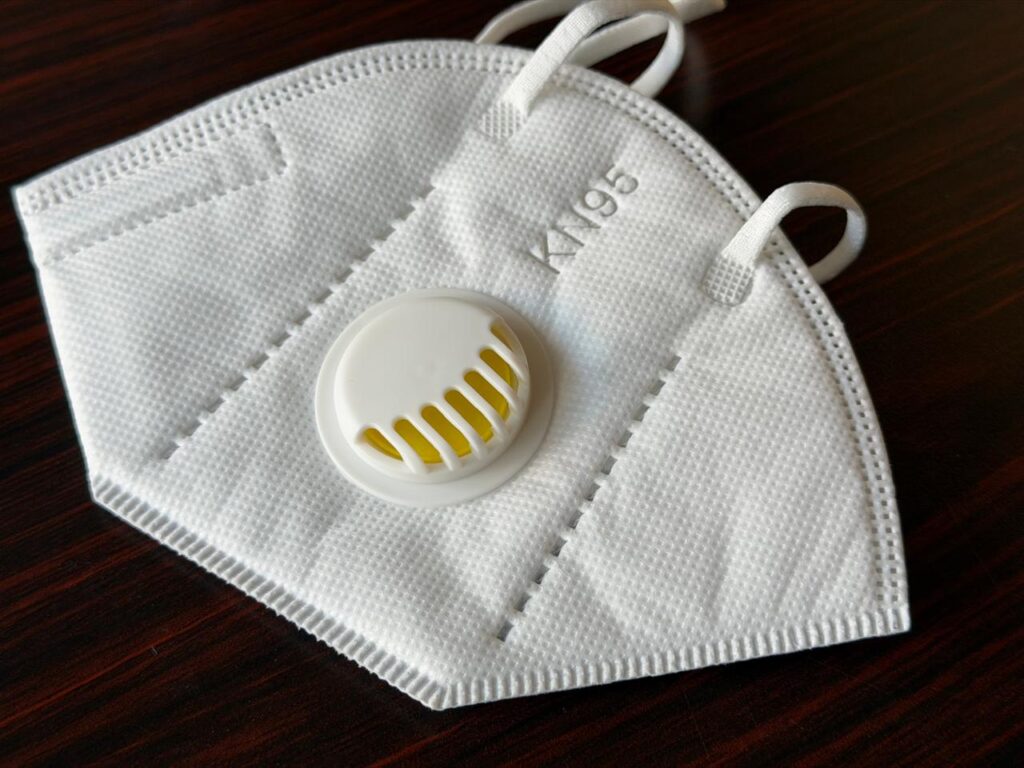 KN95 Mask-A flat-fold KN95 face mask featuring an integrated exhalation valve and elastic ear loops